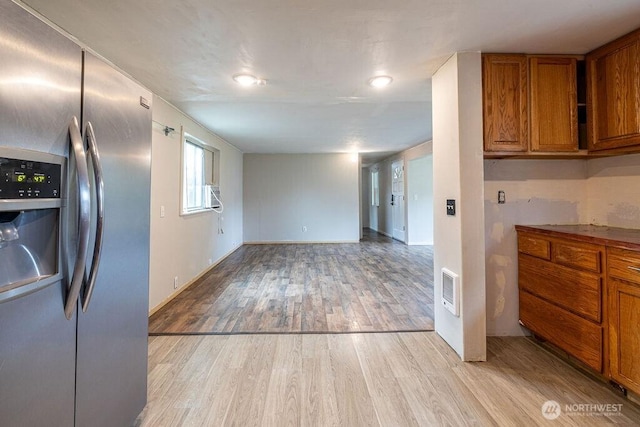 3800 Sleater Kinny Rd NE Unit 13, Olympia, WA 98506 - kitchen with stainless steel refrigerator with ice dispenser, brown cabinets, light wood finished floors, and cooling unit