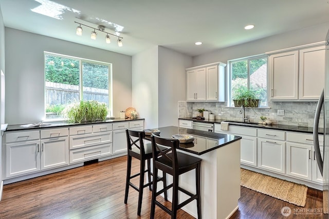 3606 Tree Farm Ct, Bellingham, WA 98226 - kitchen with dark countertops, plenty of natural light, tasteful backsplash, white cabinetry, and recessed lighting