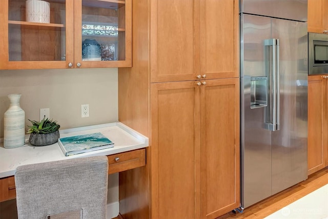 412 15th Ave, Kirkland, WA 98033 - kitchen featuring stainless steel appliances, glass insert cabinets, light countertops, and a desk