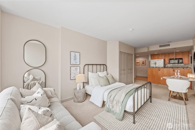 2929 1st Ave Unit 721, Seattle, WA 98121 - bedroom featuring stainless steel refrigerator, light carpet, and a closet