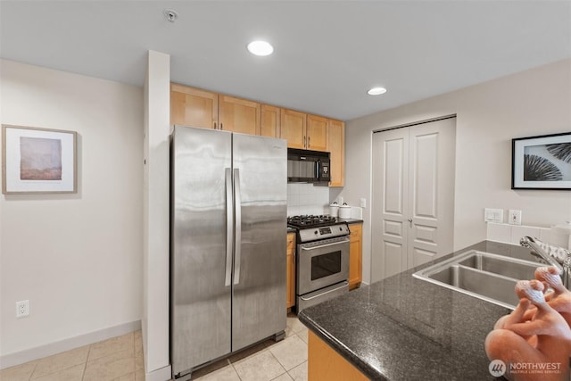 2929 1st Ave Unit 721, Seattle, WA 98121 - kitchen featuring appliances with stainless steel finishes, light brown cabinets, dark countertops, light tile patterned floors, and recessed lighting