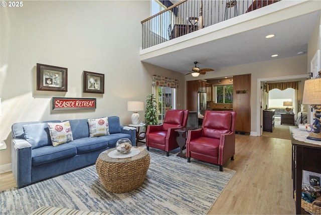 126 28th St NW, Long Beach, WA 98631 - living room with wood finished floors, a ceiling fan, a towering ceiling, and recessed lighting