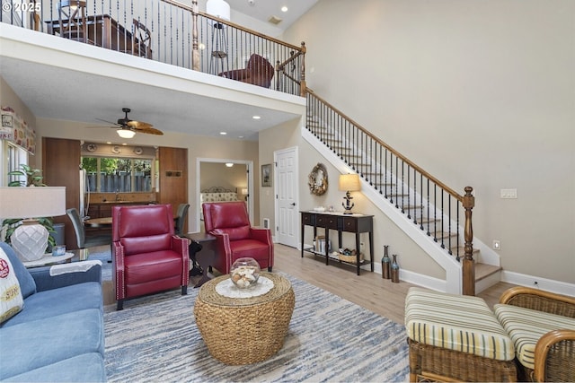 126 28th St NW, Long Beach, WA 98631 - living room featuring stairs, wood finished floors, ceiling fan, a towering ceiling, and recessed lighting