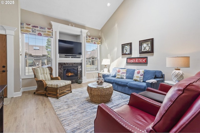 126 28th St NW, Long Beach, WA 98631 - living room featuring wood finished floors, a high end fireplace, and high vaulted ceiling