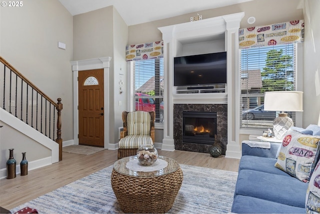 126 28th St NW, Long Beach, WA 98631 - living room featuring wood finished floors, a high end fireplace, and stairway