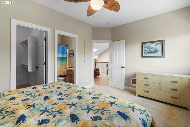 126 28th St NW, Long Beach, WA 98631 - bedroom featuring light carpet, a walk in closet, ensuite bath, and a ceiling fan