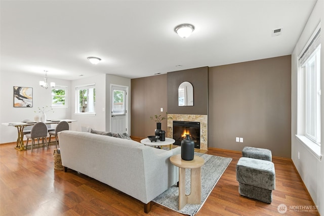 7436 S G St, Tacoma, WA 98408 - living area with wood finished floors, a chandelier, and a high end fireplace