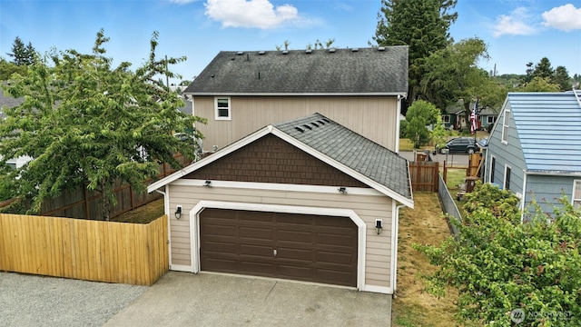 7436 S G St, Tacoma, WA 98408 - view of front of home featuring concrete driveway, roof with shingles, and an attached garage