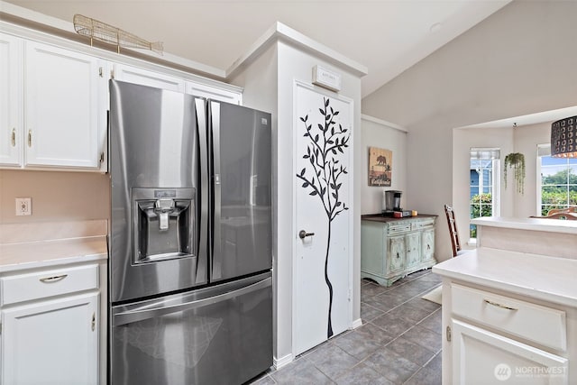 25920 202nd Ave SE, Covington, WA 98042 - kitchen featuring stainless steel refrigerator with ice dispenser, white cabinetry, light countertops, light tile patterned floors, and lofted ceiling