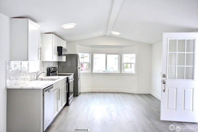210 37th St SE Unit 35, Auburn, WA 98002 - kitchen with appliances with stainless steel finishes, light wood-style flooring, light countertops, and white cabinetry