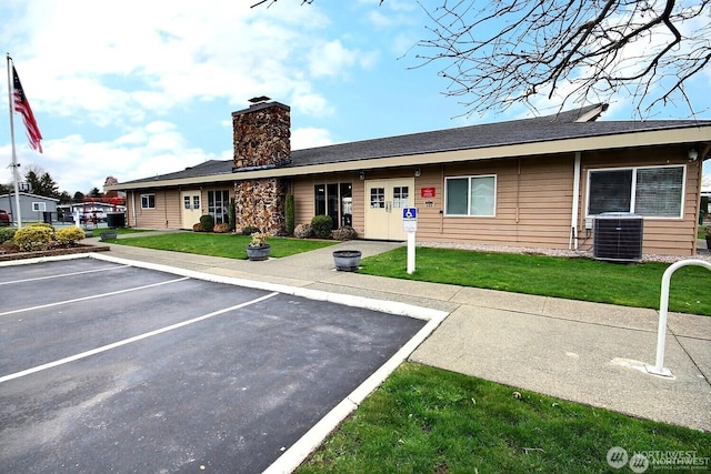210 37th St SE Unit 35, Auburn, WA 98002 - view of front facade with uncovered parking, a chimney, and a front yard