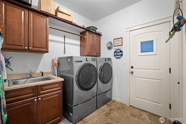 1918 Tundra Loop, Mount Vernon, WA 98273 - washroom featuring washing machine and dryer, cabinet space, and light stone finish flooring
