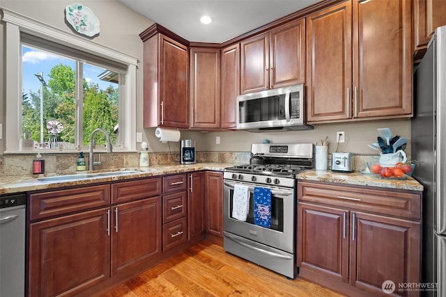 1918 Tundra Loop, Mount Vernon, WA 98273 - kitchen with appliances with stainless steel finishes, light stone counters, light wood-type flooring, and recessed lighting