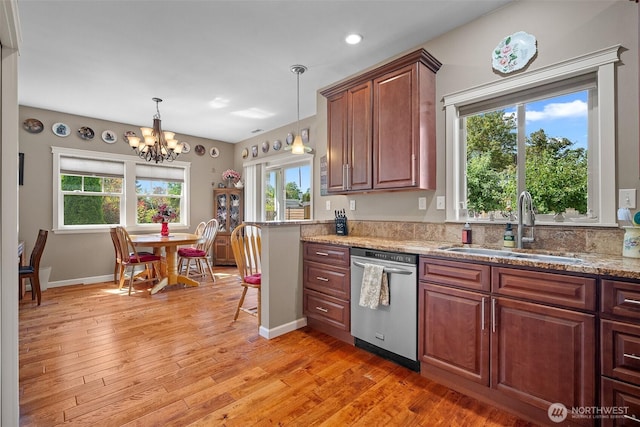1918 Tundra Loop, Mount Vernon, WA 98273 - kitchen with dishwasher, light wood finished floors, decorative light fixtures, a chandelier, and light stone counters