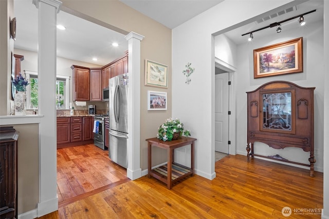1918 Tundra Loop, Mount Vernon, WA 98273 - kitchen with appliances with stainless steel finishes, decorative columns, light wood-style floors, rail lighting, and recessed lighting