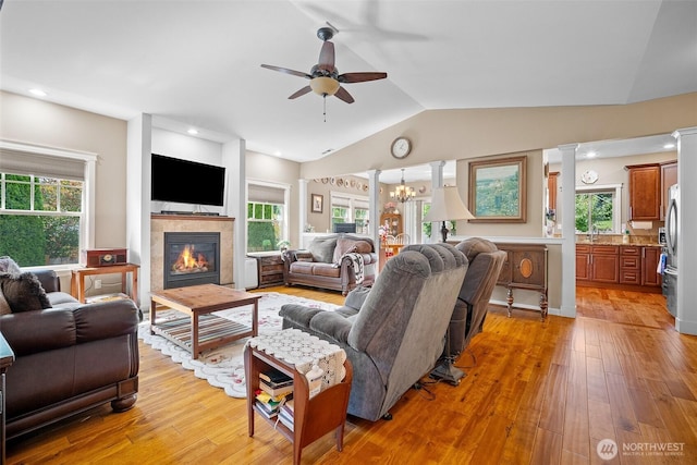 1918 Tundra Loop, Mount Vernon, WA 98273 - living area with ceiling fan, vaulted ceiling, a tiled fireplace, light wood-style floors, and a chandelier