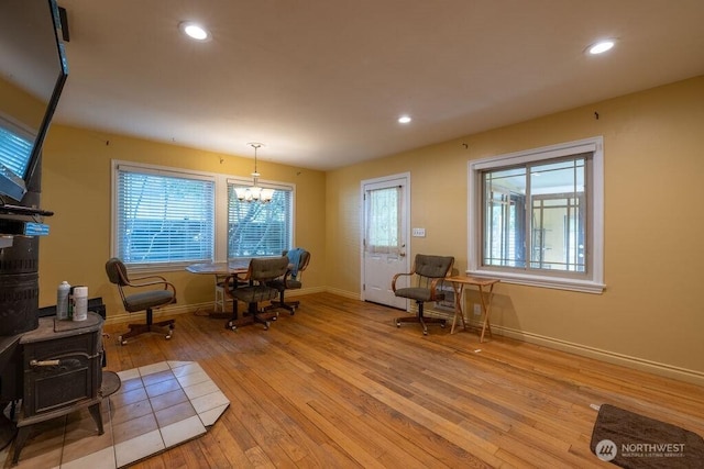 1427 E 3rd St, Port Angeles, WA 98362 - sitting room featuring light wood-style floors, a chandelier, recessed lighting, and a wood stove