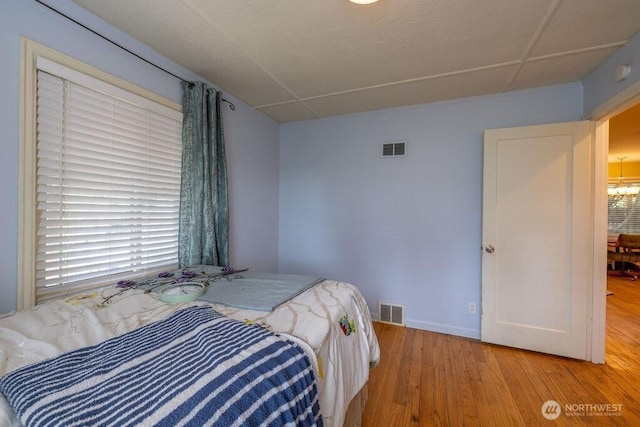 1427 E 3rd St, Port Angeles, WA 98362 - bedroom featuring light wood finished floors and a chandelier