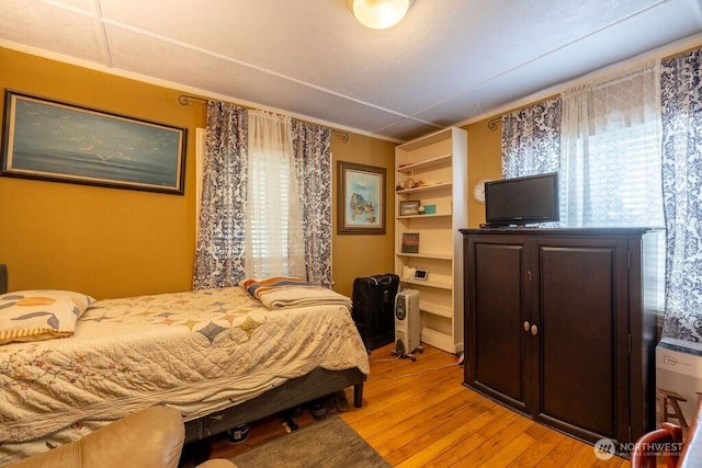 1427 E 3rd St, Port Angeles, WA 98362 - bedroom with light wood-style floors and crown molding