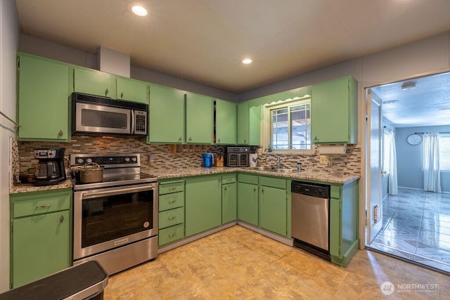 1427 E 3rd St, Port Angeles, WA 98362 - kitchen with appliances with stainless steel finishes, backsplash, light countertops, and recessed lighting