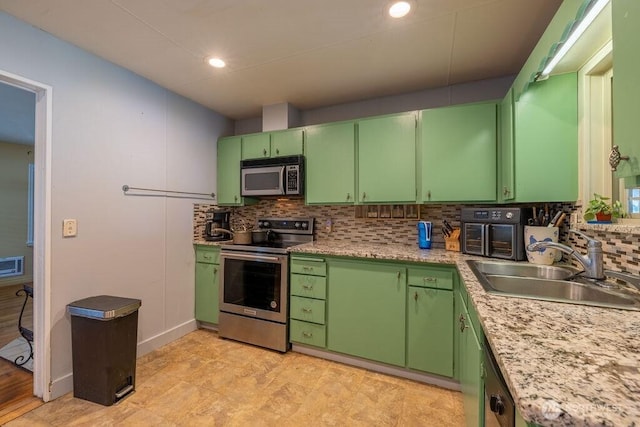 1427 E 3rd St, Port Angeles, WA 98362 - kitchen with appliances with stainless steel finishes, backsplash, light countertops, and recessed lighting