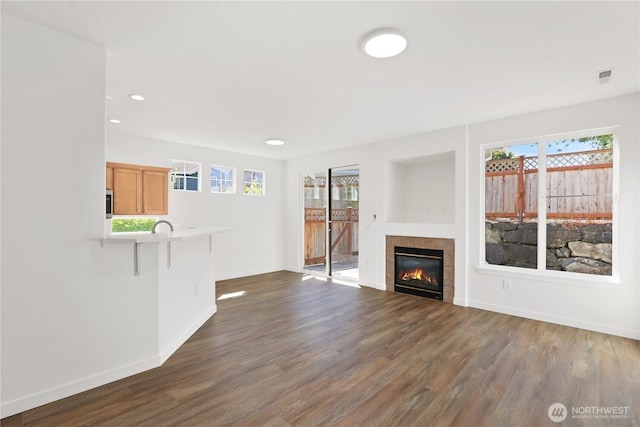 2711 SE 10th St Unit 1099, Renton, WA 98058 - unfurnished living room with dark wood-style flooring, a fireplace, and recessed lighting