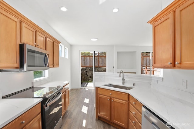 2711 SE 10th St Unit 1099, Renton, WA 98058 - kitchen featuring appliances with stainless steel finishes, wood finished floors, recessed lighting, light stone countertops, and a peninsula