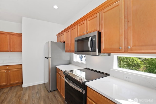 2711 SE 10th St Unit 1099, Renton, WA 98058 - kitchen with range with electric stovetop, wood finished floors, plenty of natural light, light countertops, and recessed lighting