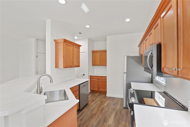 2711 SE 10th St Unit 1099, Renton, WA 98058 - kitchen with electric range oven, light wood-style flooring, recessed lighting, dishwasher, and a peninsula