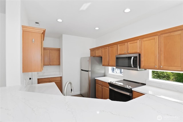 2711 SE 10th St Unit 1099, Renton, WA 98058 - kitchen featuring stainless steel appliances, healthy amount of natural light, light stone countertops, and recessed lighting