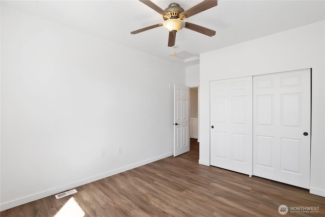 2711 SE 10th St Unit 1099, Renton, WA 98058 - unfurnished bedroom featuring wood finished floors, a closet, and a ceiling fan