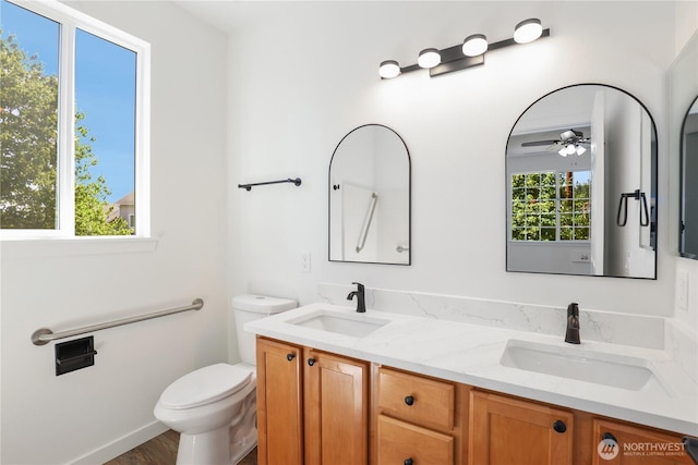 2711 SE 10th St Unit 1099, Renton, WA 98058 - full bathroom with double vanity, ceiling fan, and wood finished floors