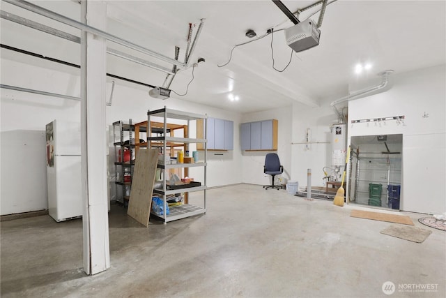 2711 SE 10th St Unit 1099, Renton, WA 98058 - garage featuring freestanding refrigerator, a garage door opener, and gas water heater