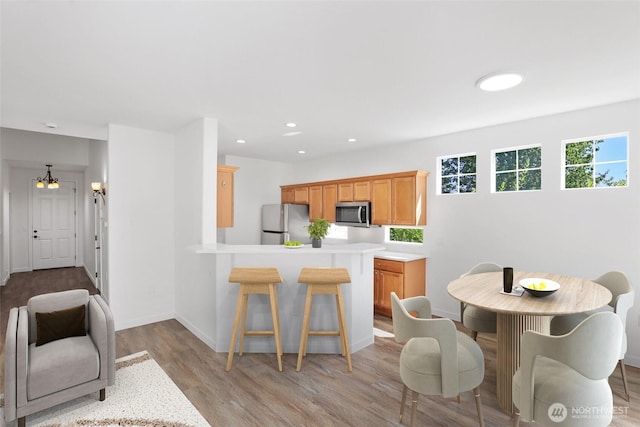 2711 SE 10th St Unit 1099, Renton, WA 98058 - dining space with light wood-type flooring and recessed lighting
