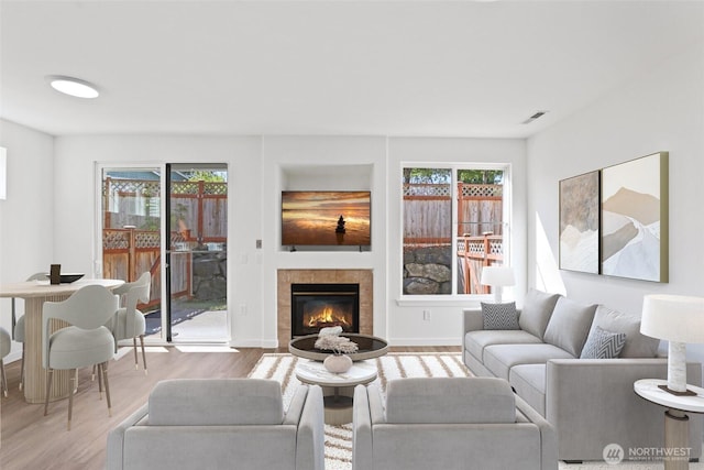 2711 SE 10th St Unit 1099, Renton, WA 98058 - living area featuring healthy amount of natural light, wood finished floors, and a fireplace