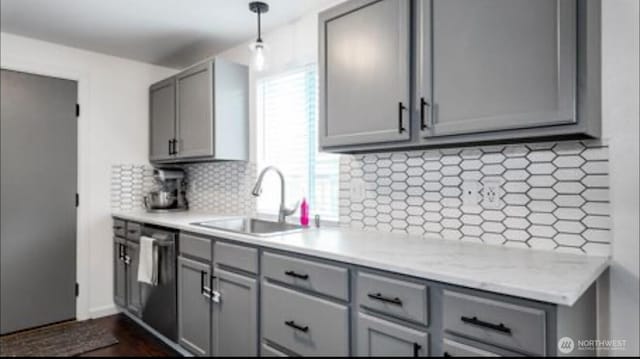 16228 Curry Ct SE, Yelm, WA 98597 - kitchen featuring gray cabinetry, backsplash, dishwasher, and decorative light fixtures