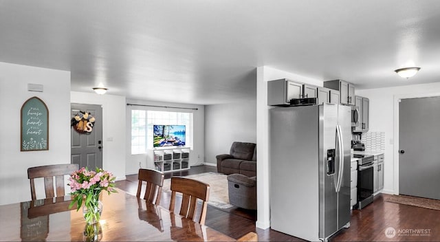 16228 Curry Ct SE, Yelm, WA 98597 - kitchen featuring stainless steel appliances, gray cabinets, tasteful backsplash, dark wood-type flooring, and light countertops