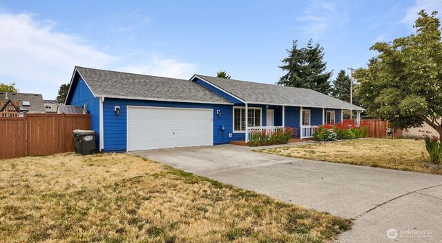 16228 Curry Ct SE, Yelm, WA 98597 - single story home featuring a porch, a garage, concrete driveway, and roof with shingles