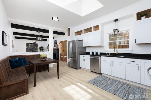 4020 N 34th St, Tacoma, WA 98407 - kitchen featuring open shelves, beam ceiling, light wood finished floors, appliances with stainless steel finishes, and white cabinetry