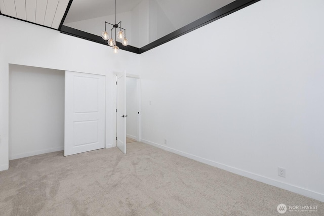 4020 N 34th St, Tacoma, WA 98407 - unfurnished bedroom with carpet flooring, high vaulted ceiling, a chandelier, and a closet