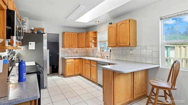 32626 46th Pl S, Auburn, WA 98001 - kitchen with stainless steel dishwasher, a peninsula, healthy amount of natural light, and light tile patterned flooring