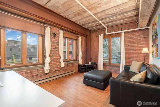 1507 Western Ave Unit R203, Seattle, WA 98101 - living room with a baseboard radiator, brick wall, wood finished floors, and wooden ceiling