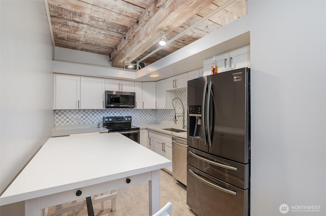1507 Western Ave Unit R203, Seattle, WA 98101 - kitchen featuring appliances with stainless steel finishes, decorative backsplash, light countertops, and white cabinetry