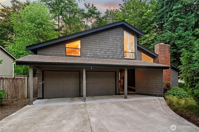 2109 130th Pl SE, Bellevue, WA 98005 - view of front facade featuring driveway, roof with shingles, an attached garage, and a chimney