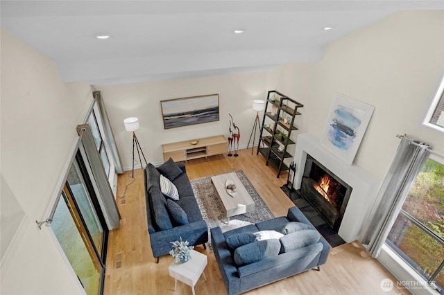 2109 130th Pl SE, Bellevue, WA 98005 - living area with wood finished floors, a fireplace with flush hearth, and recessed lighting