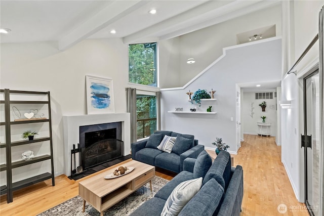 2109 130th Pl SE, Bellevue, WA 98005 - living area featuring high vaulted ceiling, light wood-style flooring, beamed ceiling, a fireplace with flush hearth, and recessed lighting