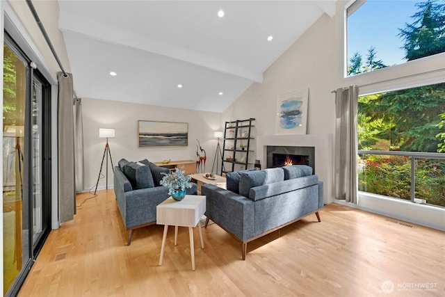 2109 130th Pl SE, Bellevue, WA 98005 - living area with light wood-style floors, a warm lit fireplace, beam ceiling, high vaulted ceiling, and recessed lighting