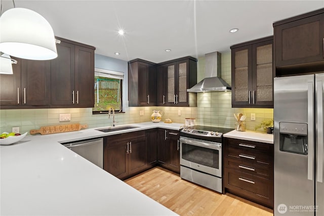 2109 130th Pl SE, Bellevue, WA 98005 - kitchen with stainless steel appliances, wall chimney range hood, light countertops, dark brown cabinetry, and tasteful backsplash