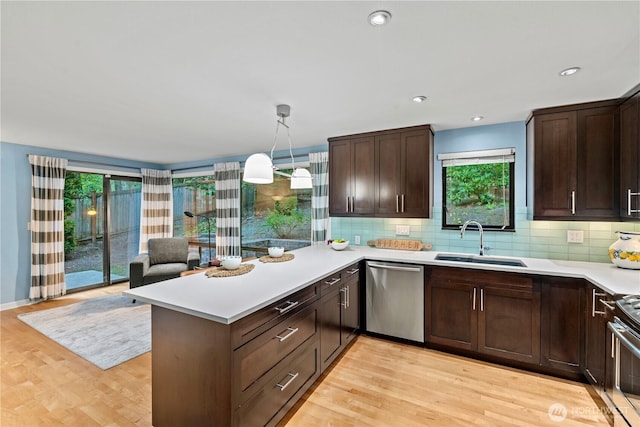 2109 130th Pl SE, Bellevue, WA 98005 - kitchen featuring appliances with stainless steel finishes, light countertops, healthy amount of natural light, a peninsula, and recessed lighting