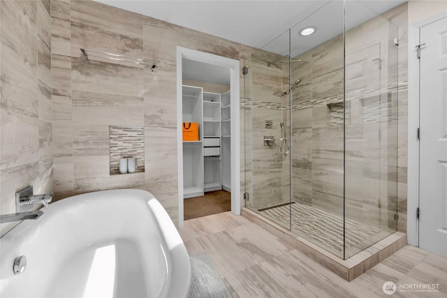 2109 130th Pl SE, Bellevue, WA 98005 - full bathroom with a soaking tub, a stall shower, a spacious closet, tile walls, and recessed lighting